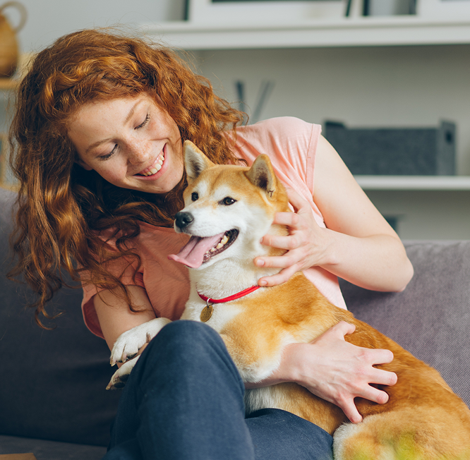 A customer lying on the floor hugging her dog