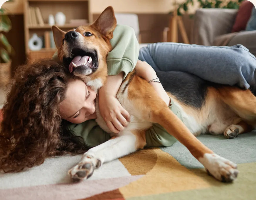 A woman lying on the floor with her German Shepherd